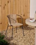 Eltiera stackable chair in synthetic rattan and black steel frame