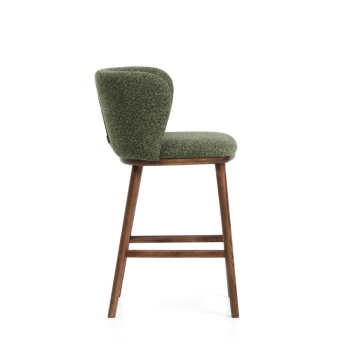 Ciselia stool in thick dark green chenille and solid ash wood legs with a walnut finish.