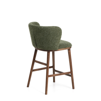 Ciselia stool in thick dark green chenille and solid ash wood legs with a walnut finish.